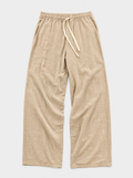 The Bastia Trouser — sand linen-cotton wide-leg drawstring trouser, front view
