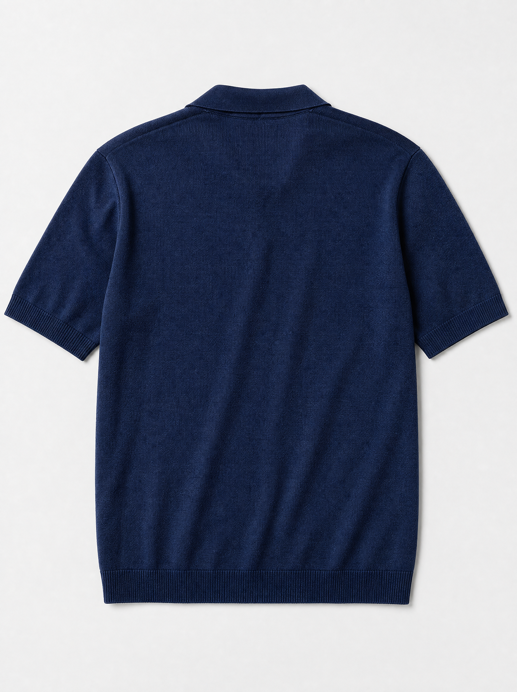 The Portofino Polo — navy fine-gauge knit cotton short-sleeve henley polo, back view